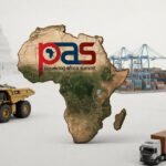 African and U.S. delegates in suits talking in a Washington, D.C. conference hall with a “Powering Africa” summit banner behind them, symbolising negotiations over energy, critical minerals and investment between the US and African countries.