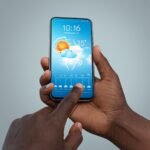 African meteorologists in a Lomé training room working on laptops while a facilitator presents climate graphs on a screen, symbolising how local climate data is being turned into evidence for Africa’s next climate pledges.