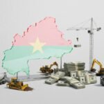 Unfinished flyover on the outskirts of Ouagadougou with concrete pillars above busy traffic, symbolising Burkina Faso’s $64‑billion bet on new infrastructure and economic transformation amid insecurity