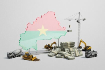 Unfinished flyover on the outskirts of Ouagadougou with concrete pillars above busy traffic, symbolising Burkina Faso’s $64‑billion bet on new infrastructure and economic transformation amid insecurity