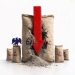 Dangote cement truck parked beside stacks of Dangote‑branded cement bags at a plant in Cameroon, illustrating how political unrest cut sales despite large installed capacity.