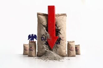 Dangote cement truck parked beside stacks of Dangote‑branded cement bags at a plant in Cameroon, illustrating how political unrest cut sales despite large installed capacity.